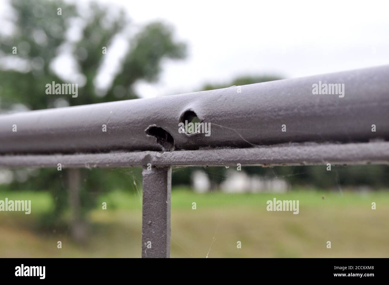 Bullet holes on the railing of the bridge, obtained during the war. Brest Fortress. Stock Photo