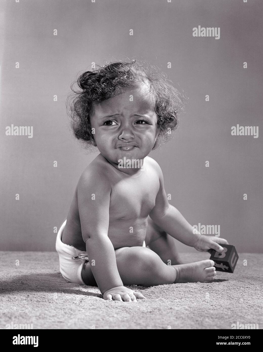 1940s 1950s creative smiling African-American boy toddler sitting