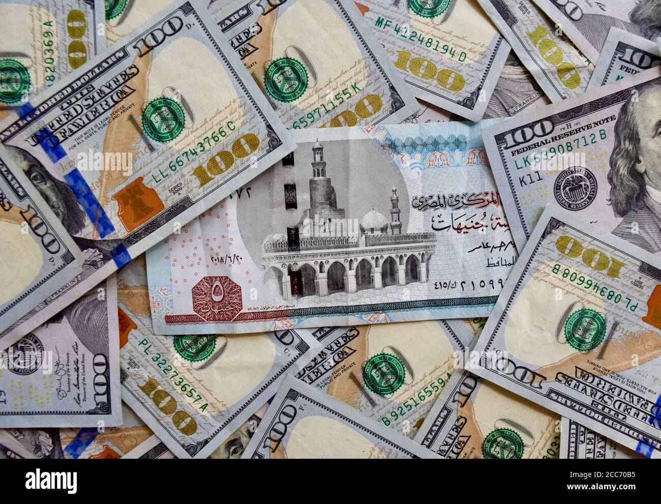 egypt-national-banknote-on-top-of-usa-national-currency-top-view-of-mixed-american-dollar-banknotes-egypt-and-usa-paper-money-5-pounds-and-us-dolla-2CC70B5.jpg