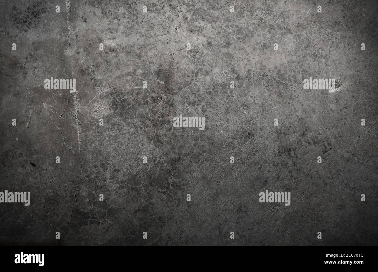 Rough textured gray concrete background with spotlight shining on it Stock Photo