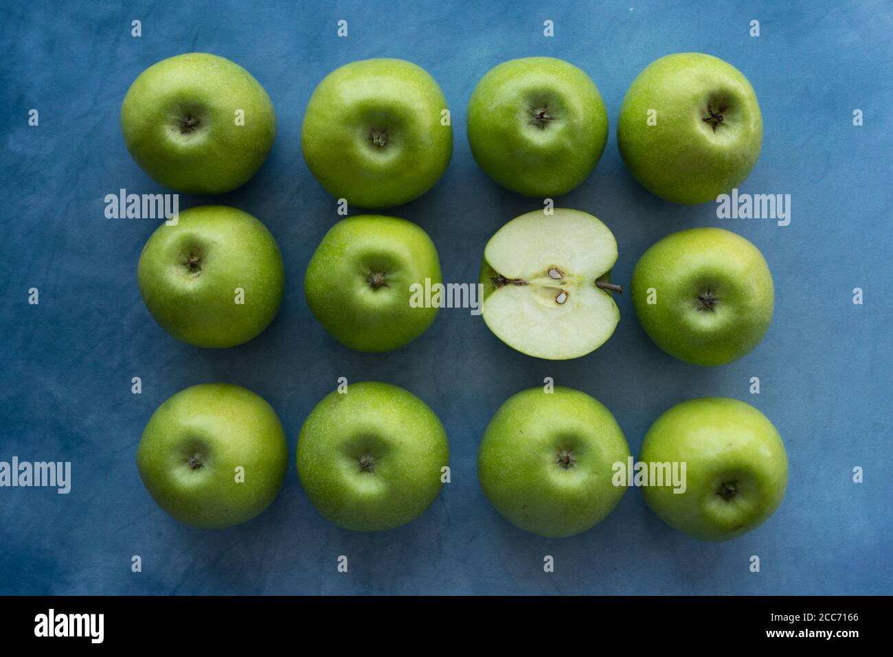 Bright green apples on blue background. Stock Photo