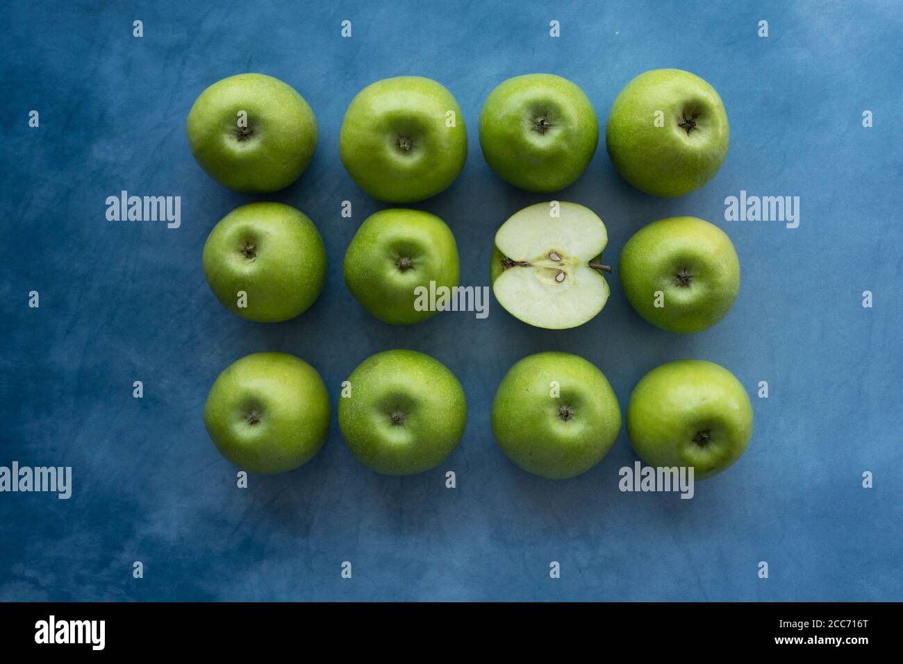 Bright green apples on blue background. Stock Photo