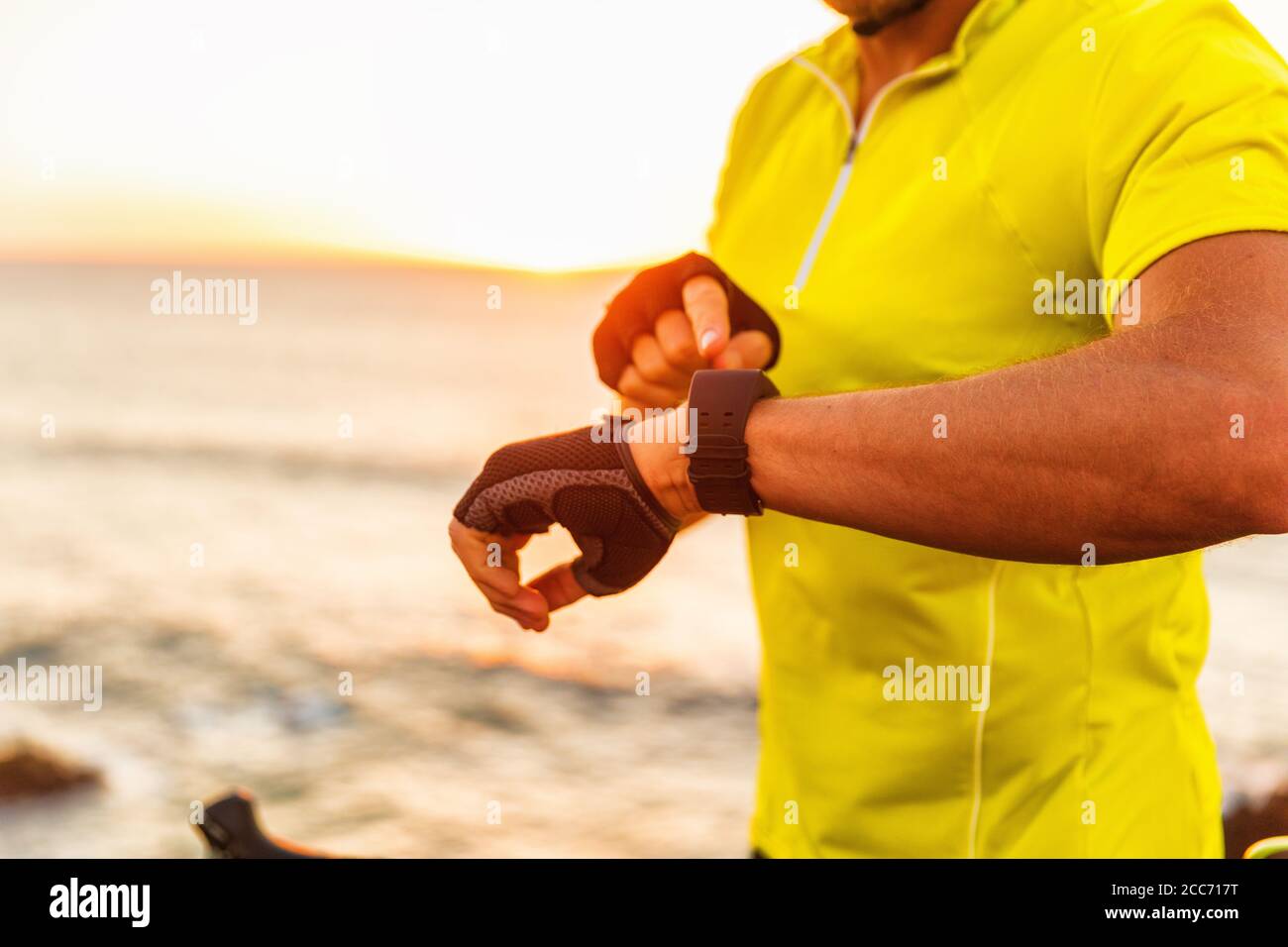 Sport smartwatch fitness tracking app triathlon man biking analyzing