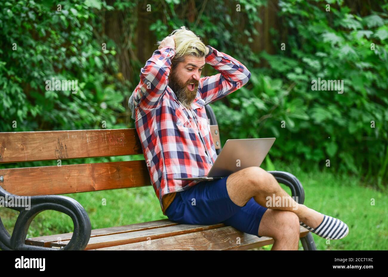 Fresh air. Mobile internet. Online shopping. Agile business. Bearded guy sit bench park nature background. Work and relax. Working online. Hipster inspired work in park. Modern laptop. Remote job. Stock Photo