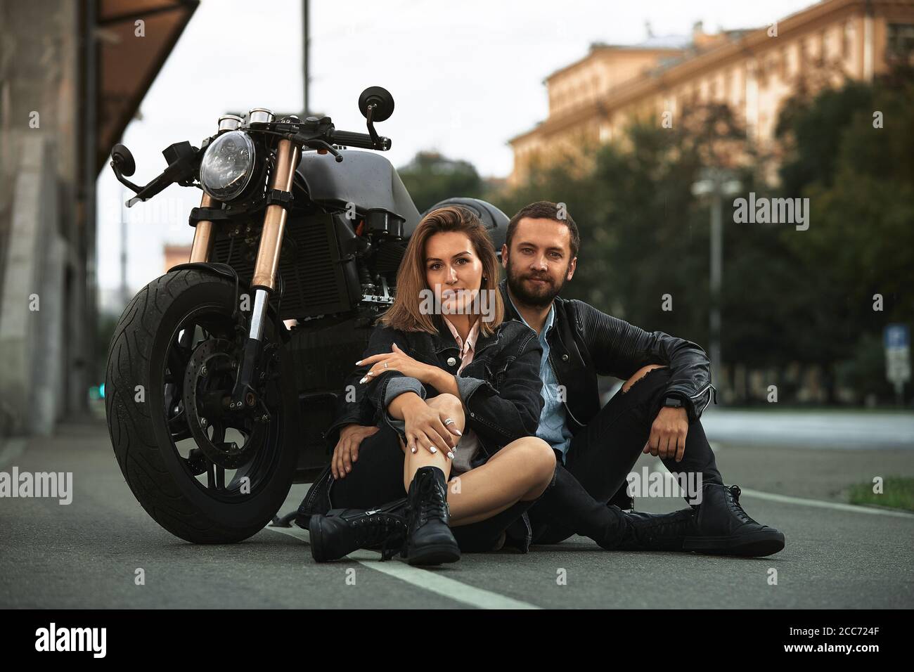 Young smiling couple posing near motor bike with sandwitches and coffee  Stock Photo - Alamy