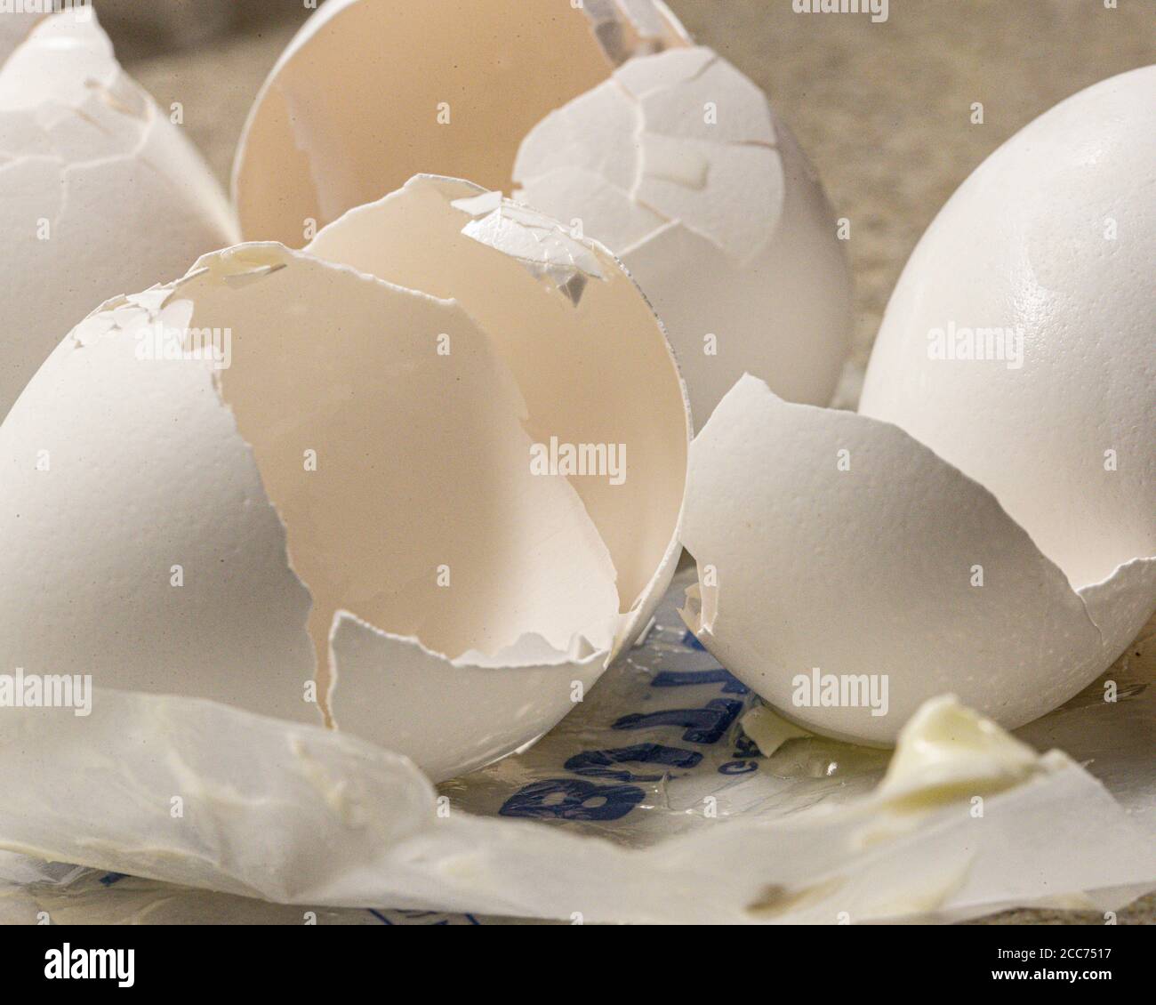 egg shells from baking eggs on empty butter wrapper Stock Photo