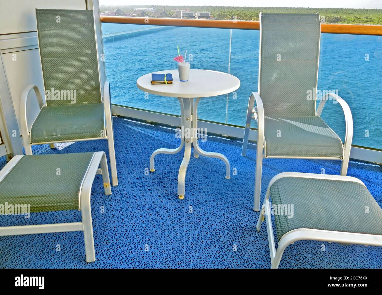 Empty lounge chairs on a cruise ship stateroom balcony Stock Photo