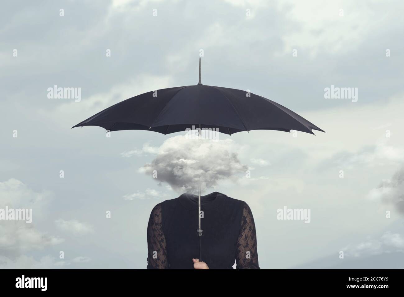 elegant woman with cloud head sheltering herself from the rain with umbrella Stock Photo
