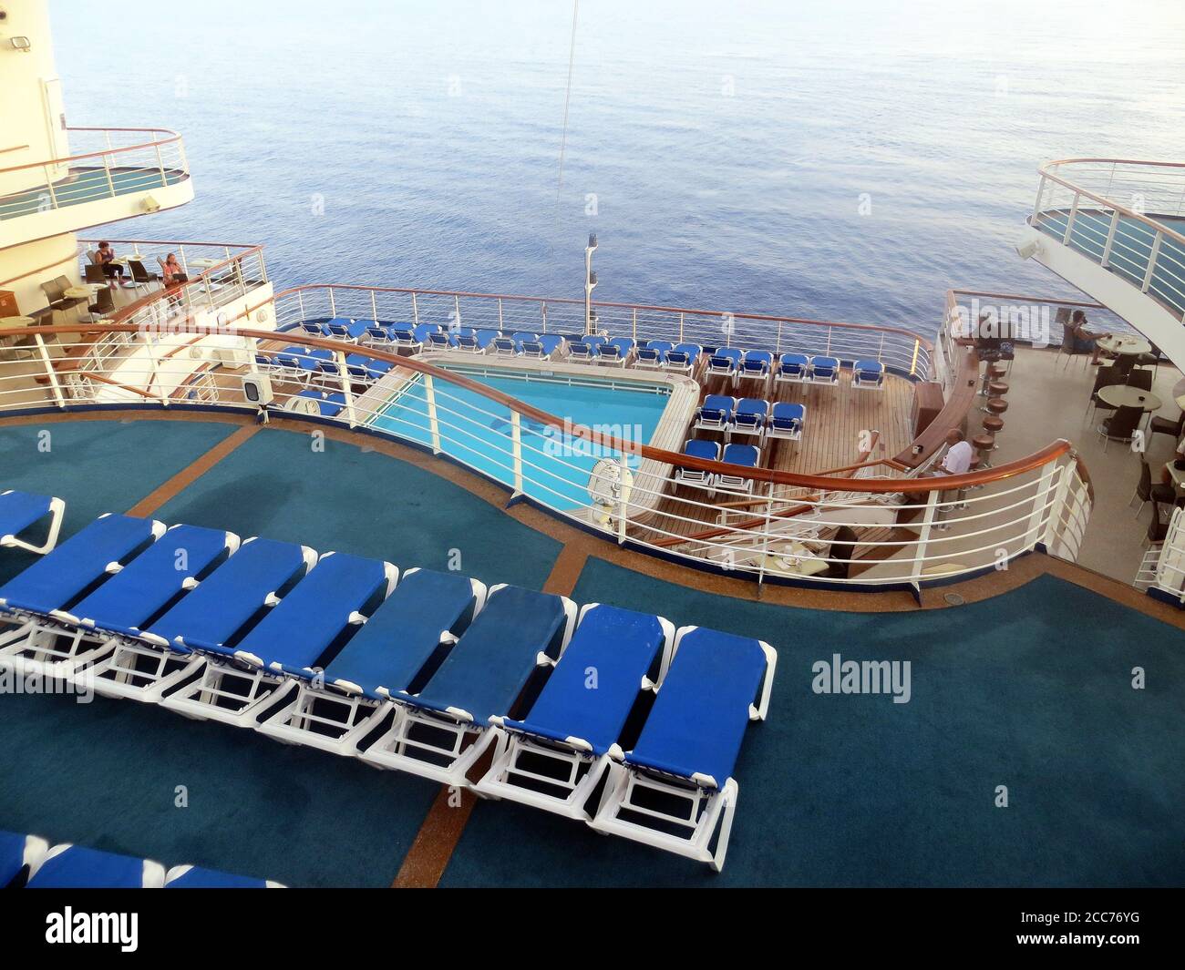 Empty deck chairs and swimming pool on a cruise ship Stock Photo