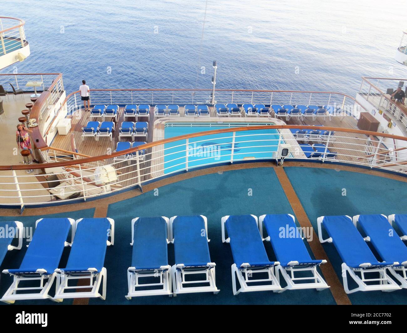 Empty deck chairs and swimming pool on a cruise ship Stock Photo
