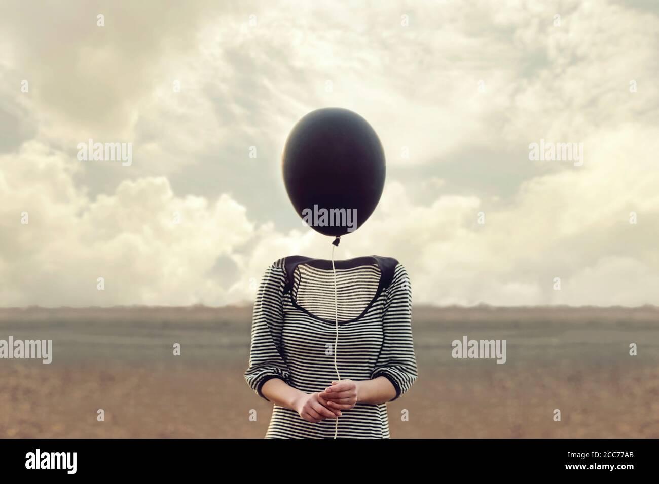 woman's head replaced by a black balloon Stock Photo