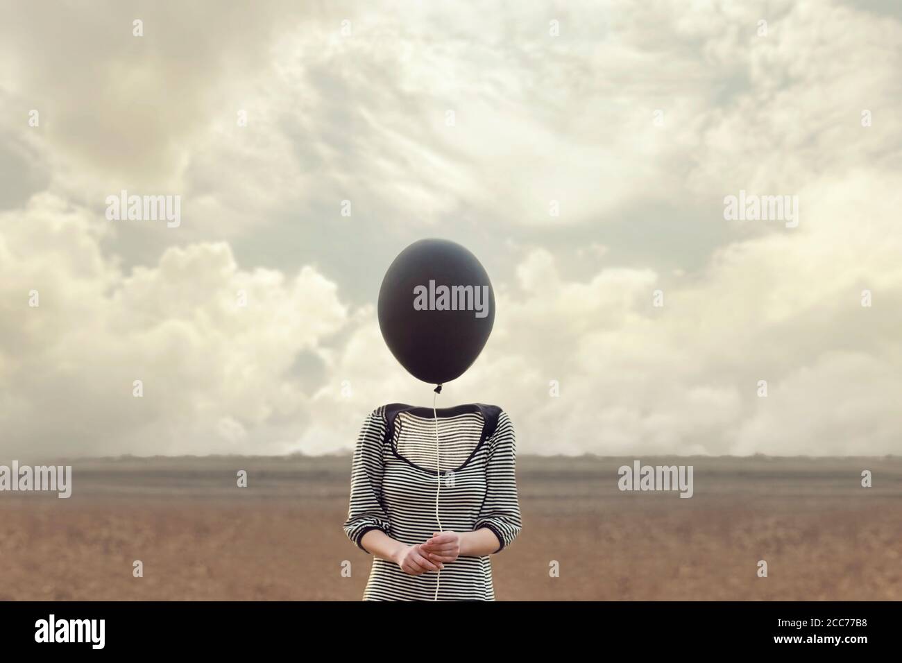 woman's head replaced by a black balloon Stock Photo