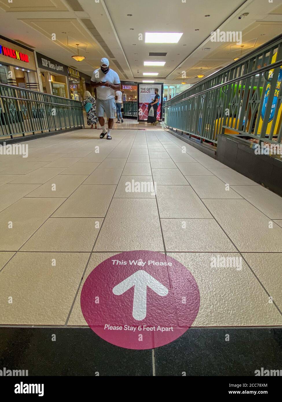 Shoppers wearing masks practice social distancing shopping as they shop