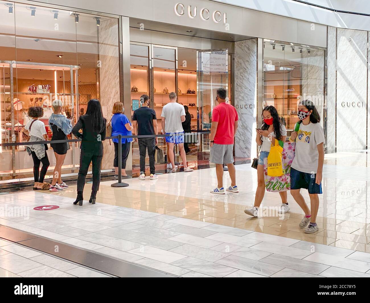 vochtigheid Centrum achterstalligheid Shoppers in masks wait in line at the Gucci store in the King of Prussia  Mall located near Philadelphia, PA - Social distancing shopping Stock Photo  - Alamy