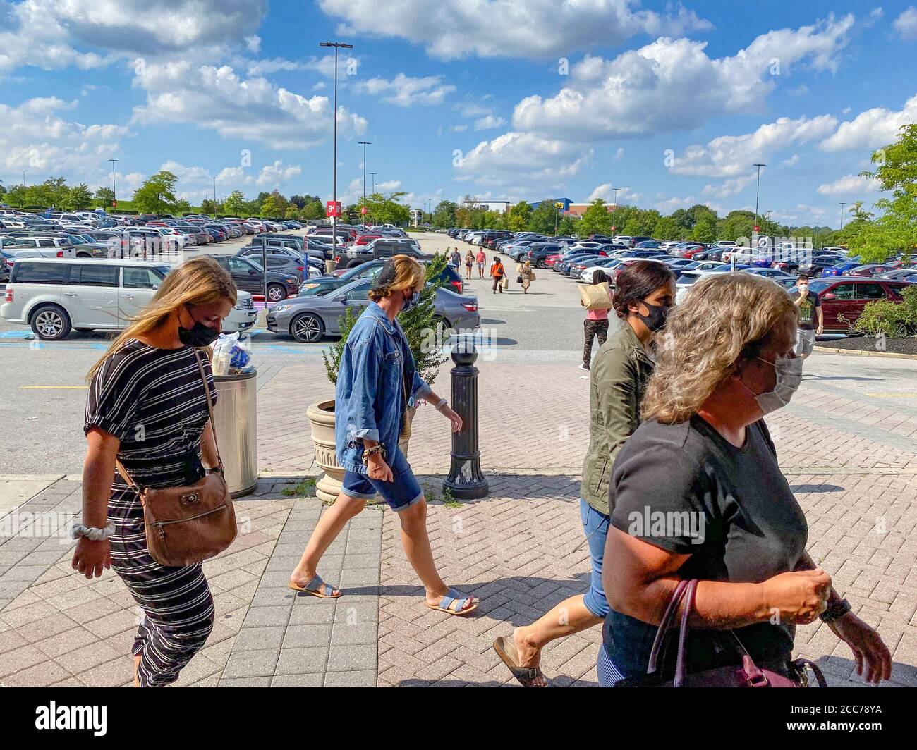 Shoppers wearing masks practice social distancing shopping as they shop