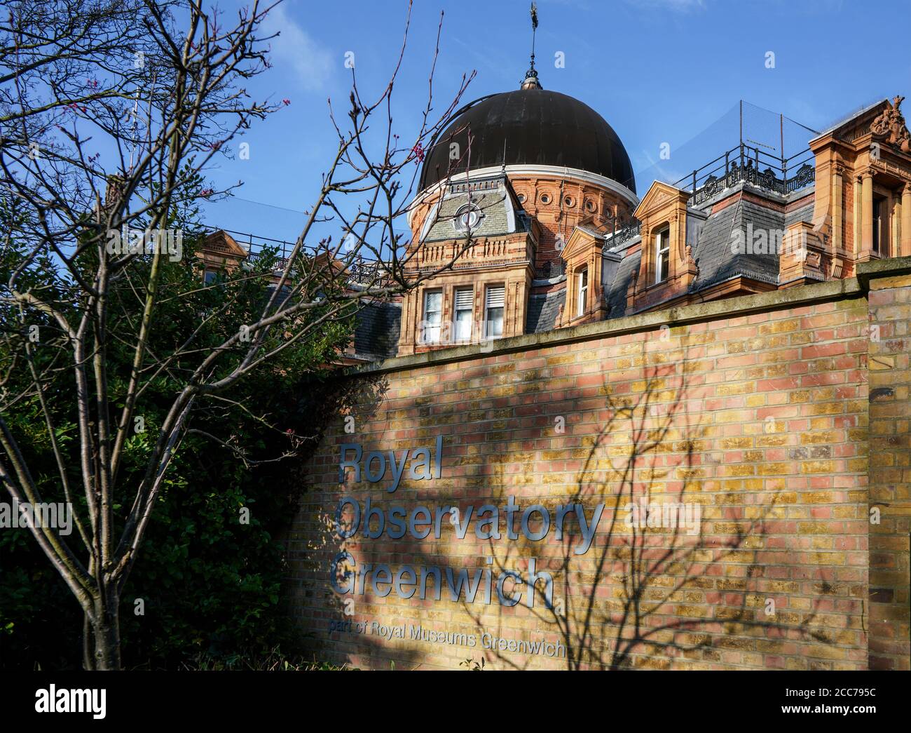 London, United Kingdom - February 02, 2019: Royal Observatory Greenwich building dome (founded 1675) with sign near entrance on sunny spring day. Stock Photo