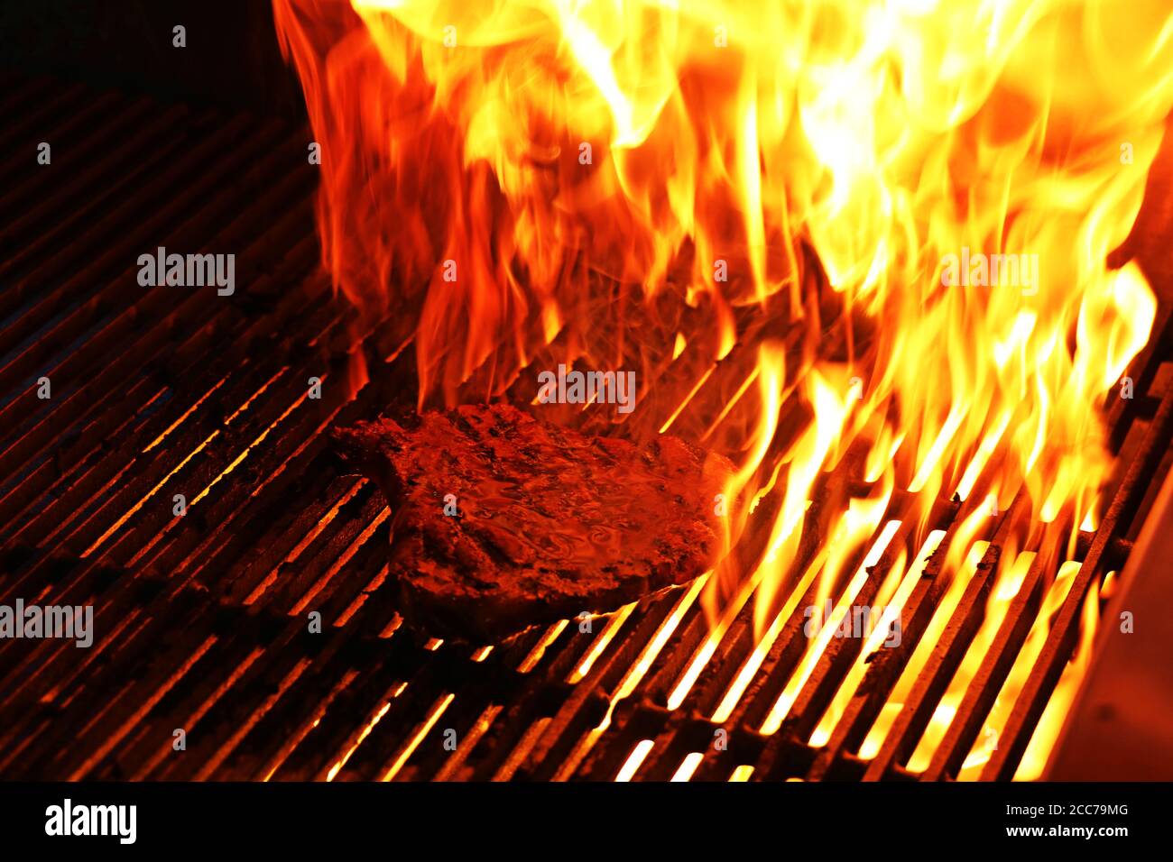 beef steak cooking on a grill with fire flames Stock Photo - Alamy