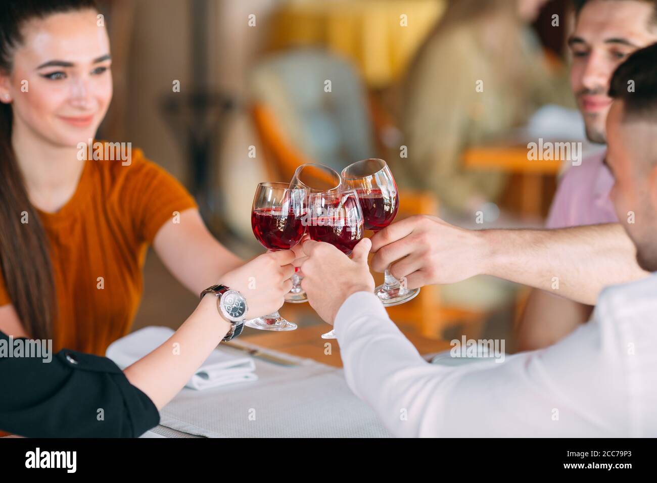 friends-drink-wine-on-the-terrace-of-the-restaurant-2CC79P3.jpg