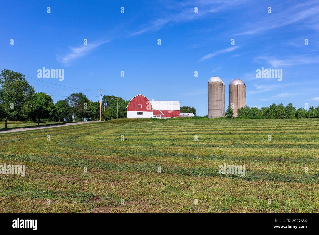 Family farm with a red barn and pair of silos. Classic rural farm scene ...