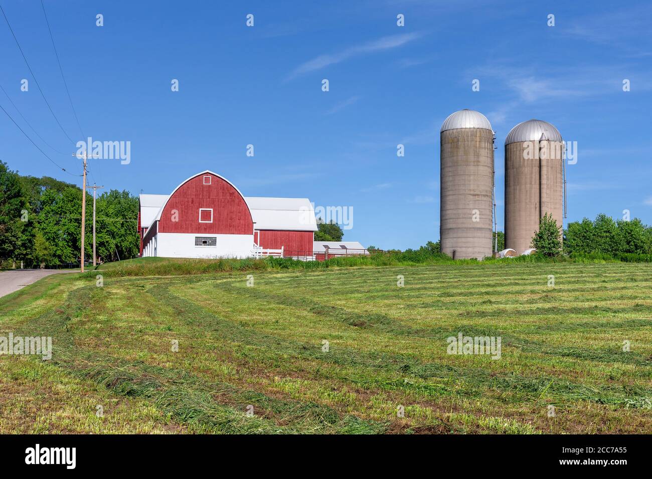 Family farm with a red barn and pair of silos. Classic rural farm scene ...