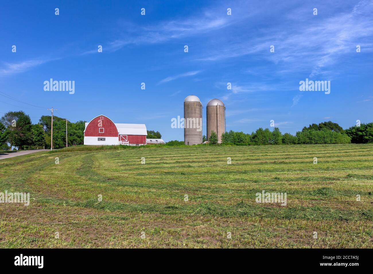 Family farm with a red barn and pair of silos. Classic rural farm scene ...