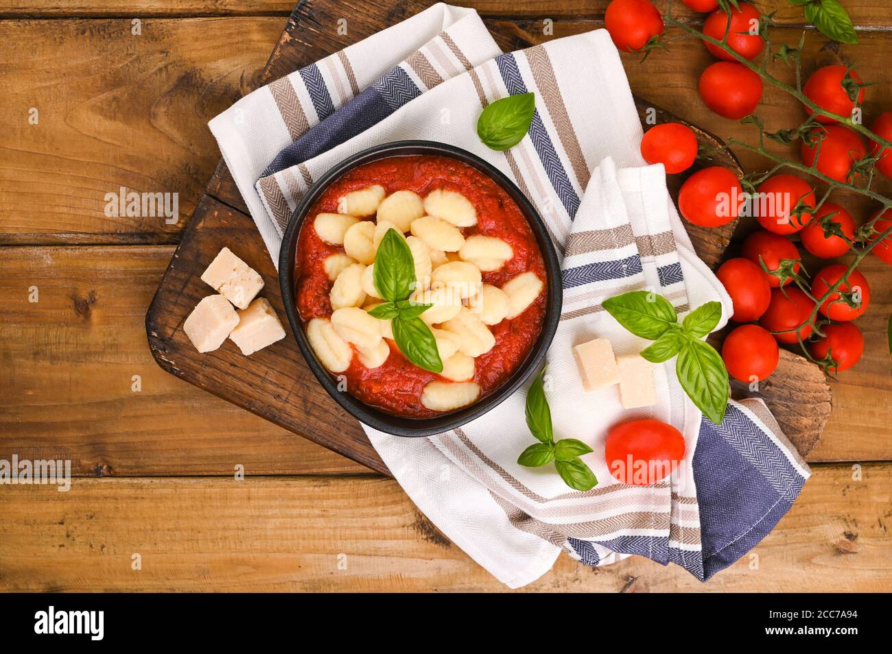 Homemade Italian Gnocchi with Red Sauce, Cheese with basil, olive oil . Close up. Home cooking. Traditional Italian cuisine from Rome and Sardinia. Above Stock Photo