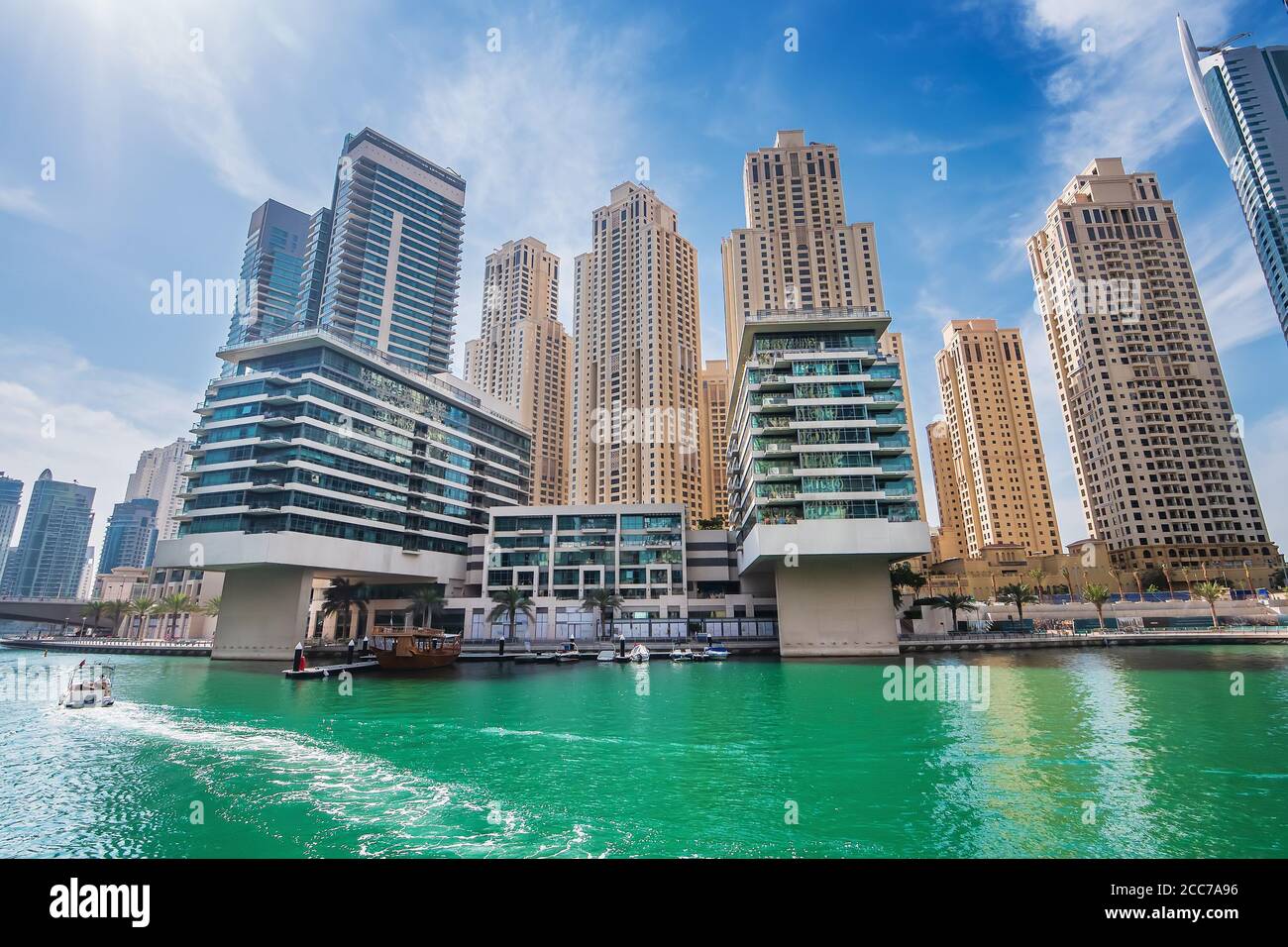 Dubai marina water canal with promenade and modern buildings, UAE
