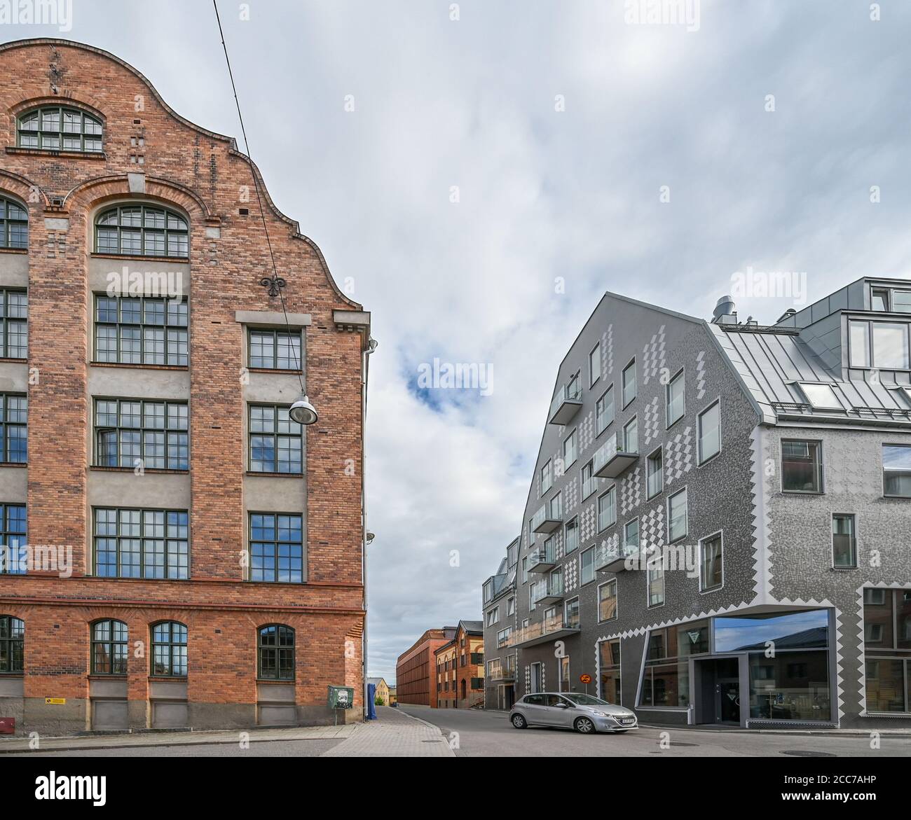 Garvaren is modern residential dbuilding in the industrial landscape of Norrkoping. The factory buildings have also been redeveloped into condos. Stock Photo