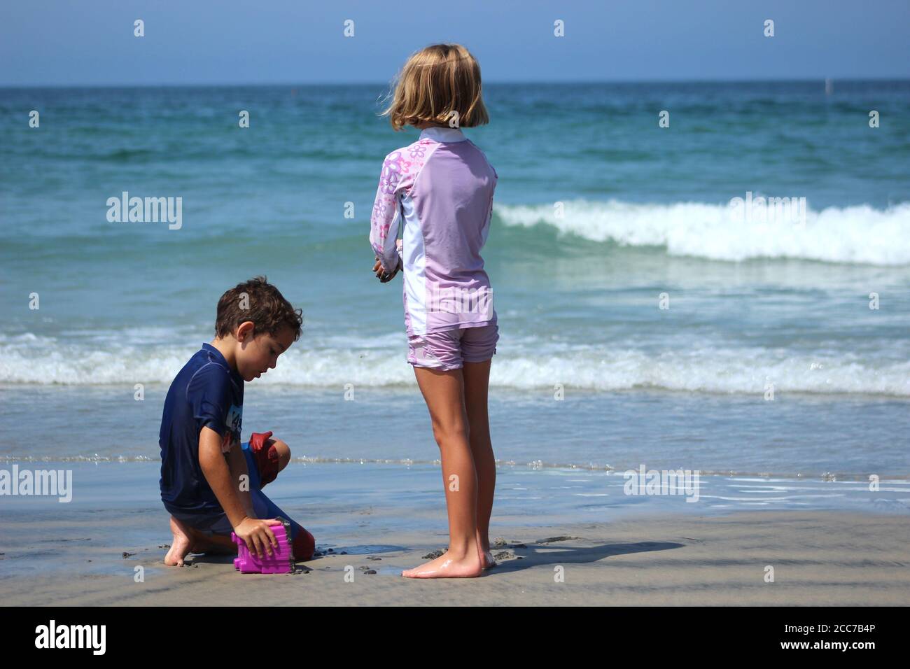 Two young children (siblings) at the beach Stock Photo