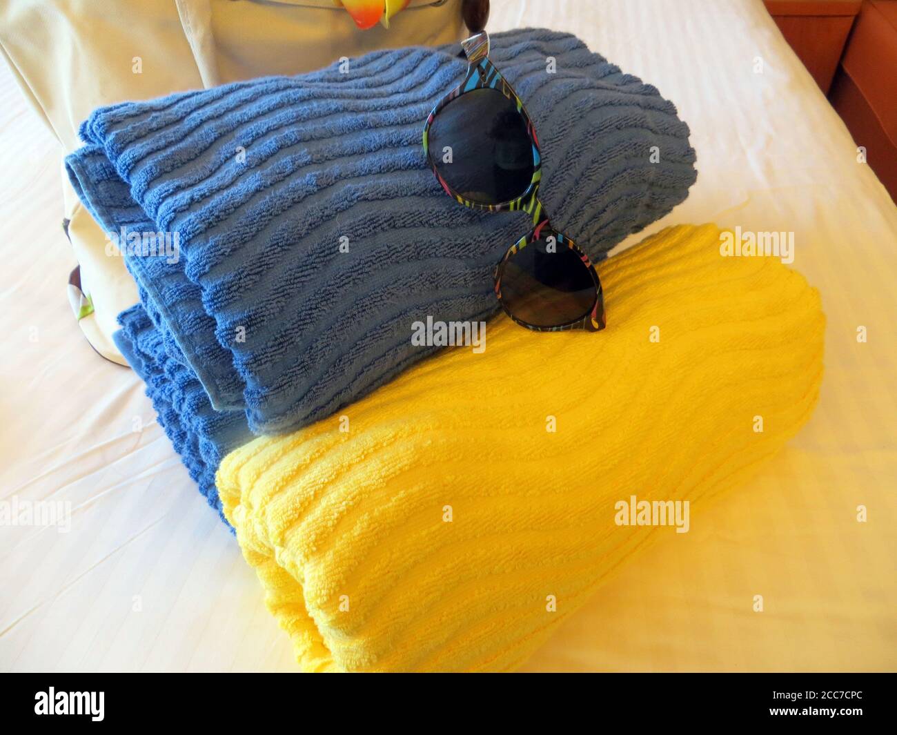 Beach towels in yellow and blue for the pool or beach Stock Photo Alamy