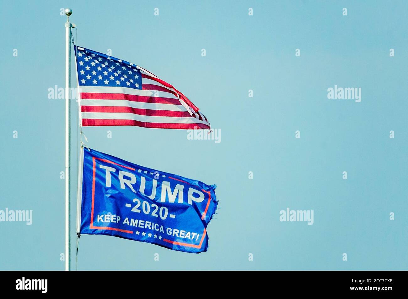 An American flag and a Trump 2020 flag fly on a pole, Aug. 17, 2020, in Coden, Alabama. The flag indicates support for American President Donald Trump. Stock Photo