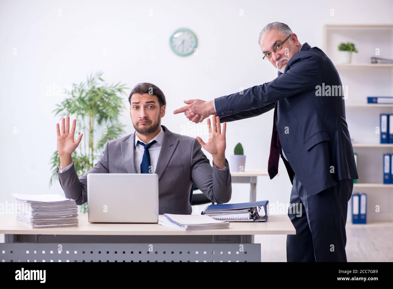 Old boss and his assistant working in the office Stock Photo - Alamy