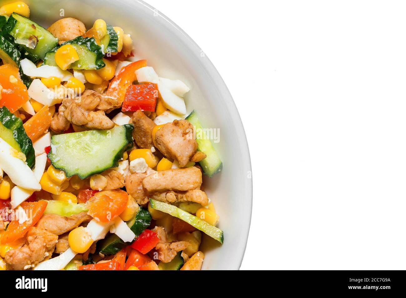 Bright vegetable salad in a white plate Isolated on a white background. Cooking a delicious dietary salad. Portion of a plate with delicious tasty veg Stock Photo