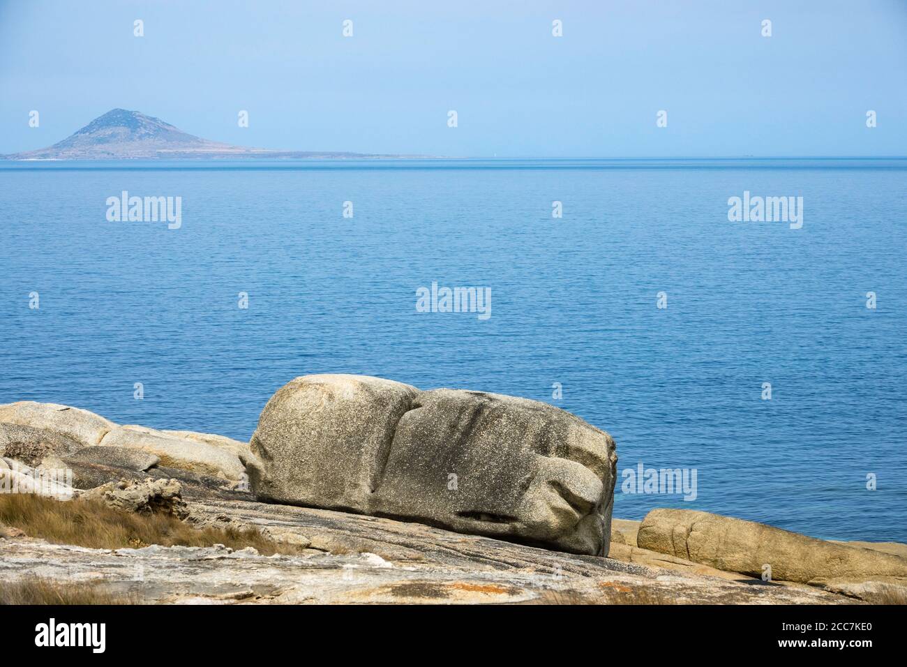 Interesting granite erosion at Trousers Point, Flinders Island, Furneaux Group, Tasmania, with Mount Chappell Island in the distance Stock Photo