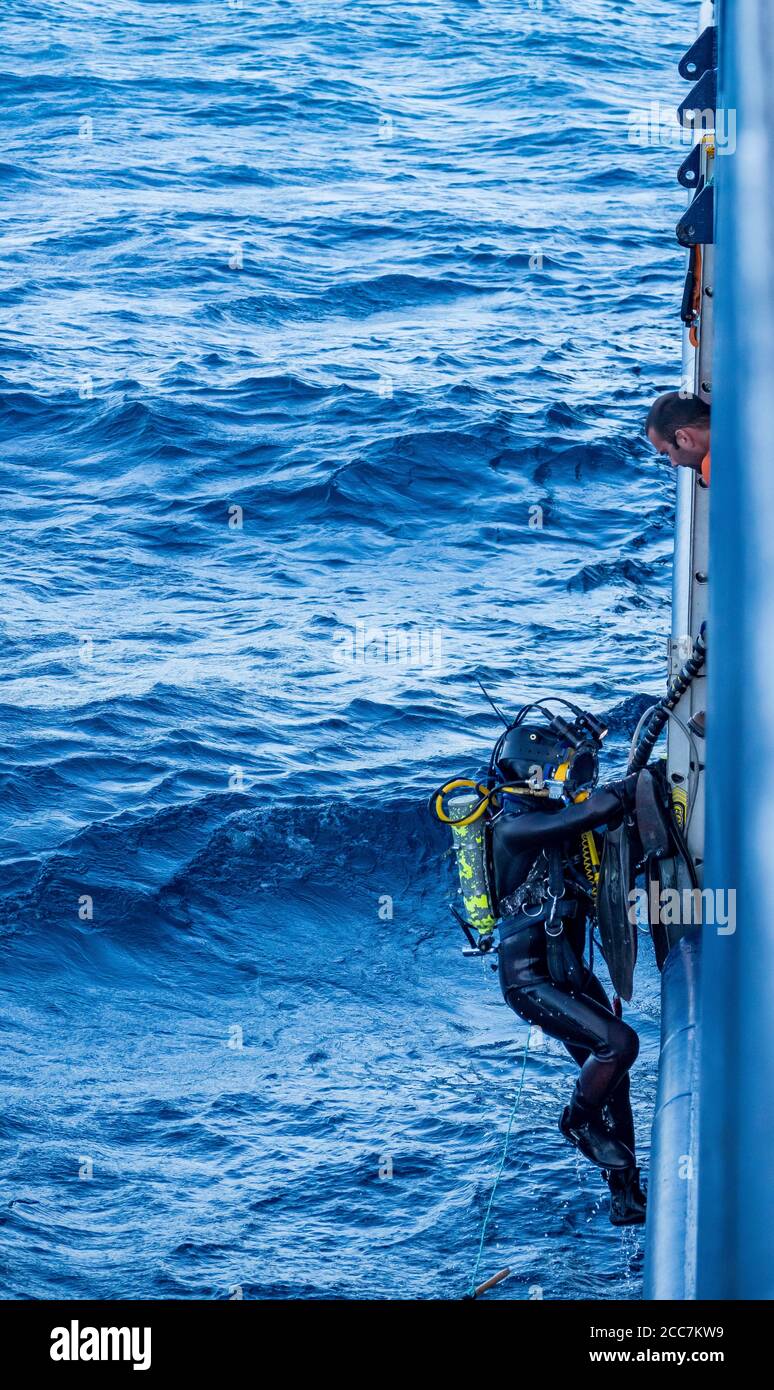 diver with hull scraper cleaning the hull of Ponant's Laperouse expedition cruise off Tasmania, Australia Stock Photo Alamy