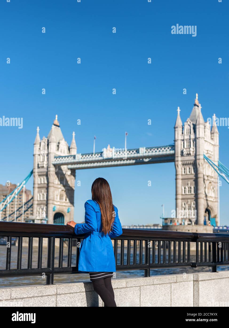 London people lifestyle city tourist woman looking at view of Tower bridge, young urban person in outerwear enjoying modern life Stock Photo