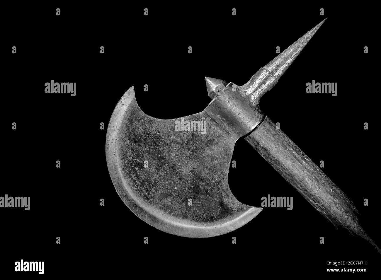 The blade of a headsman's axe. Only the blade and a bit of the handle visible. Black background, black and white image. Stock Photo