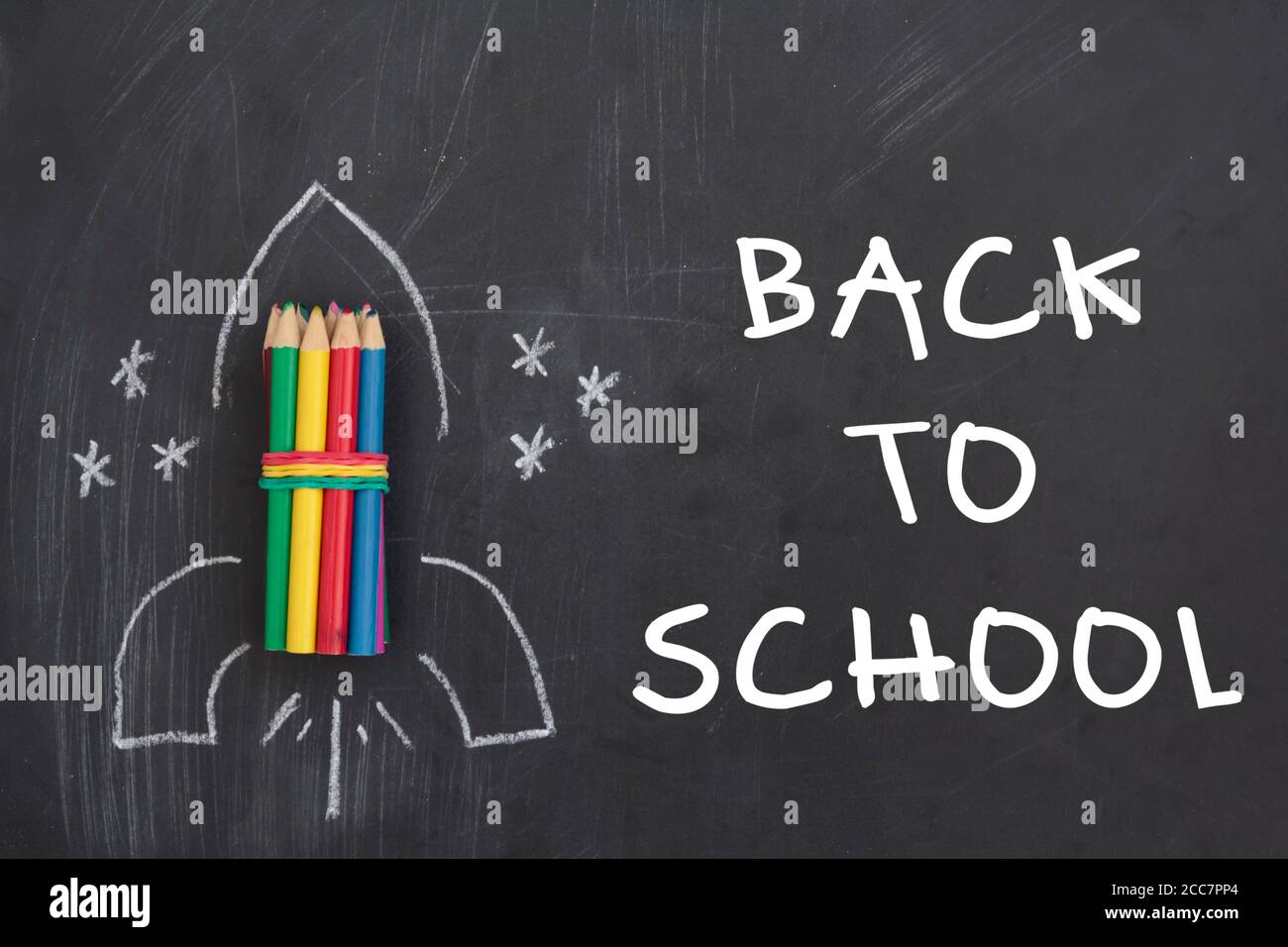 Rocket made from pencils on chalkboard with the text Back to School ...