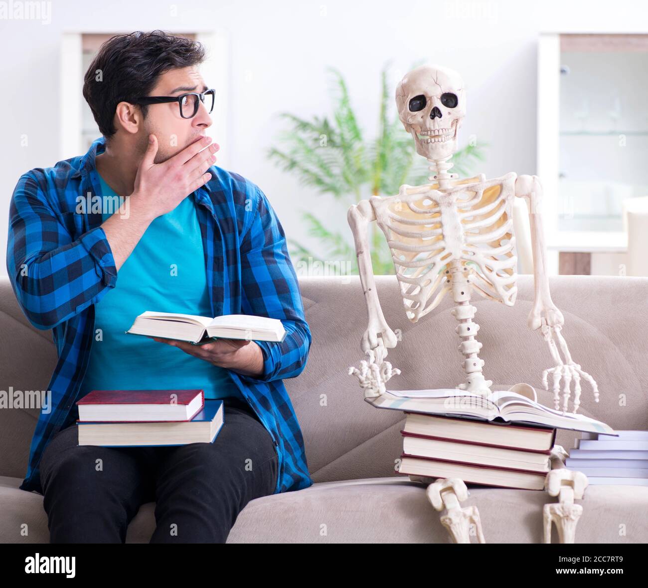 The student studying with skeleton preparing for exams Stock Photo