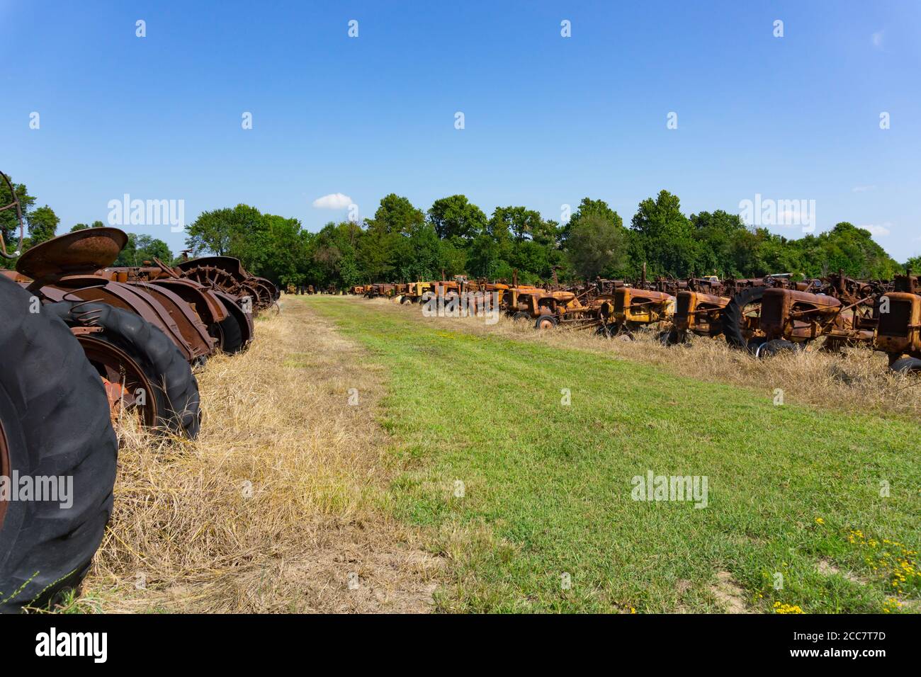 Old equipment and machinery and dead tractors lined up in field Stock ...
