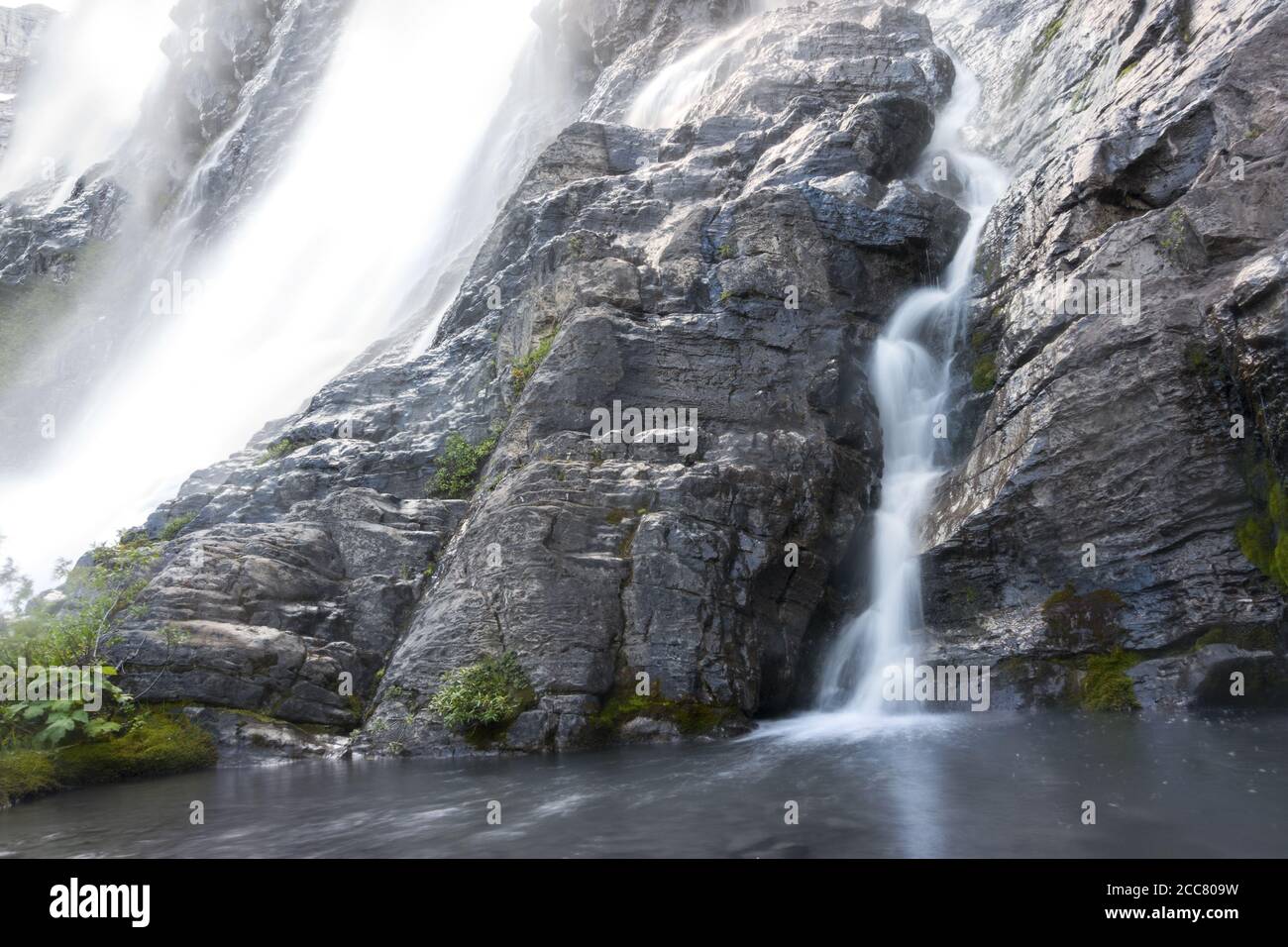 Pétain Falls Base, a Beautiful Cascading Waterfall Flowing water Stream down Rock Cliff in Elk Lakes Provincial Park, British Columbia Canada Stock Photo