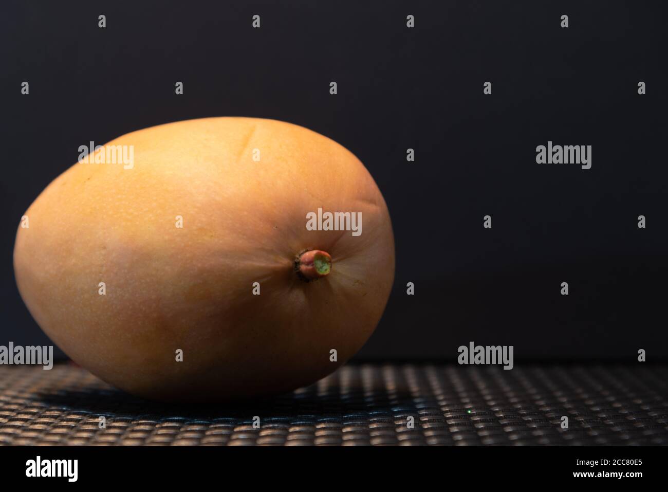 Pink mango fruits. Mango on dark background. Tropical and tasty fruit