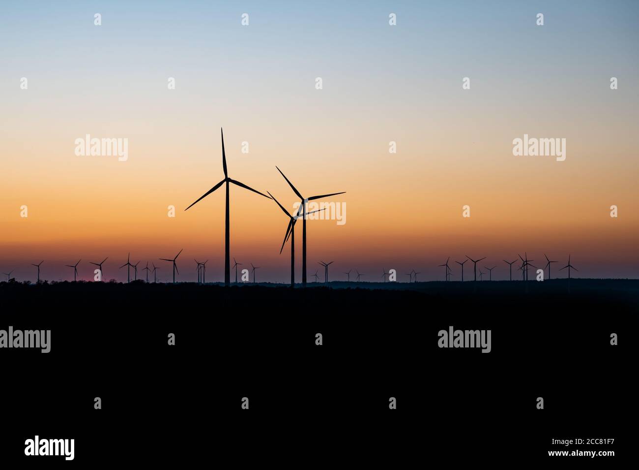 Black Silhouette of windturbines energy generator on an amazing sunset ...