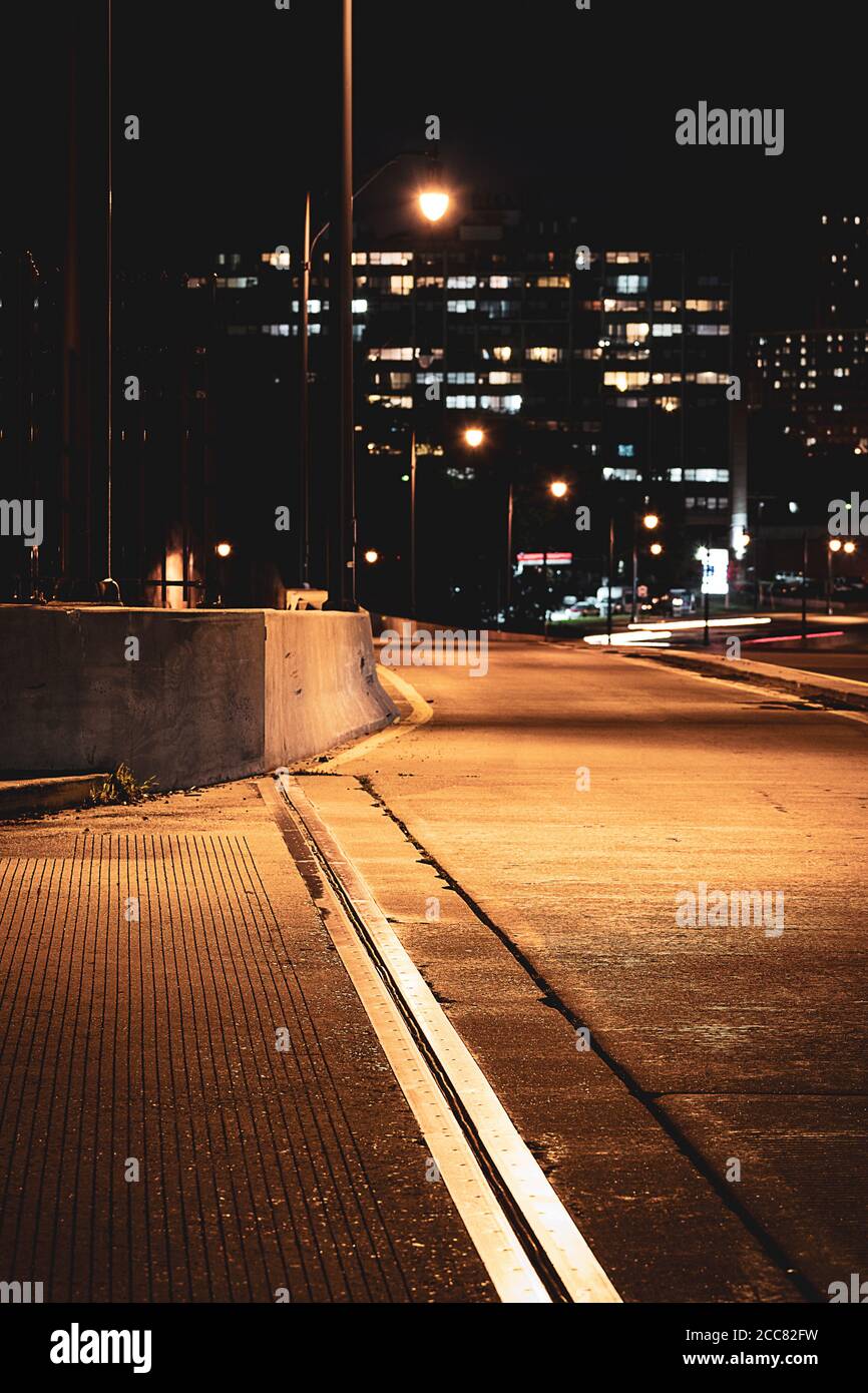 Selective focus on mysterious empty road under streetlights ...