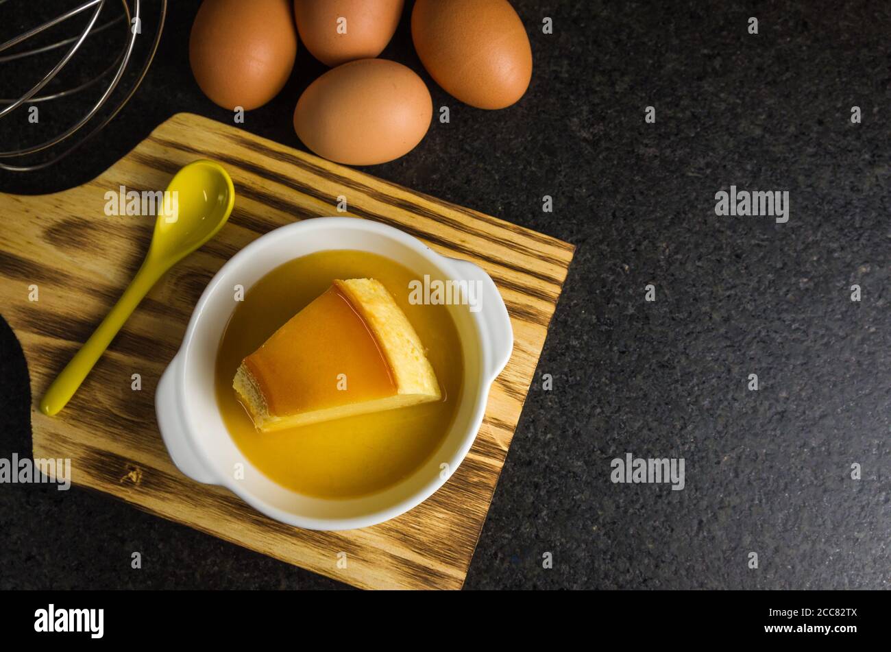 Traditional Brazilian dessert, milk pudding on dark background. Stock Photo
