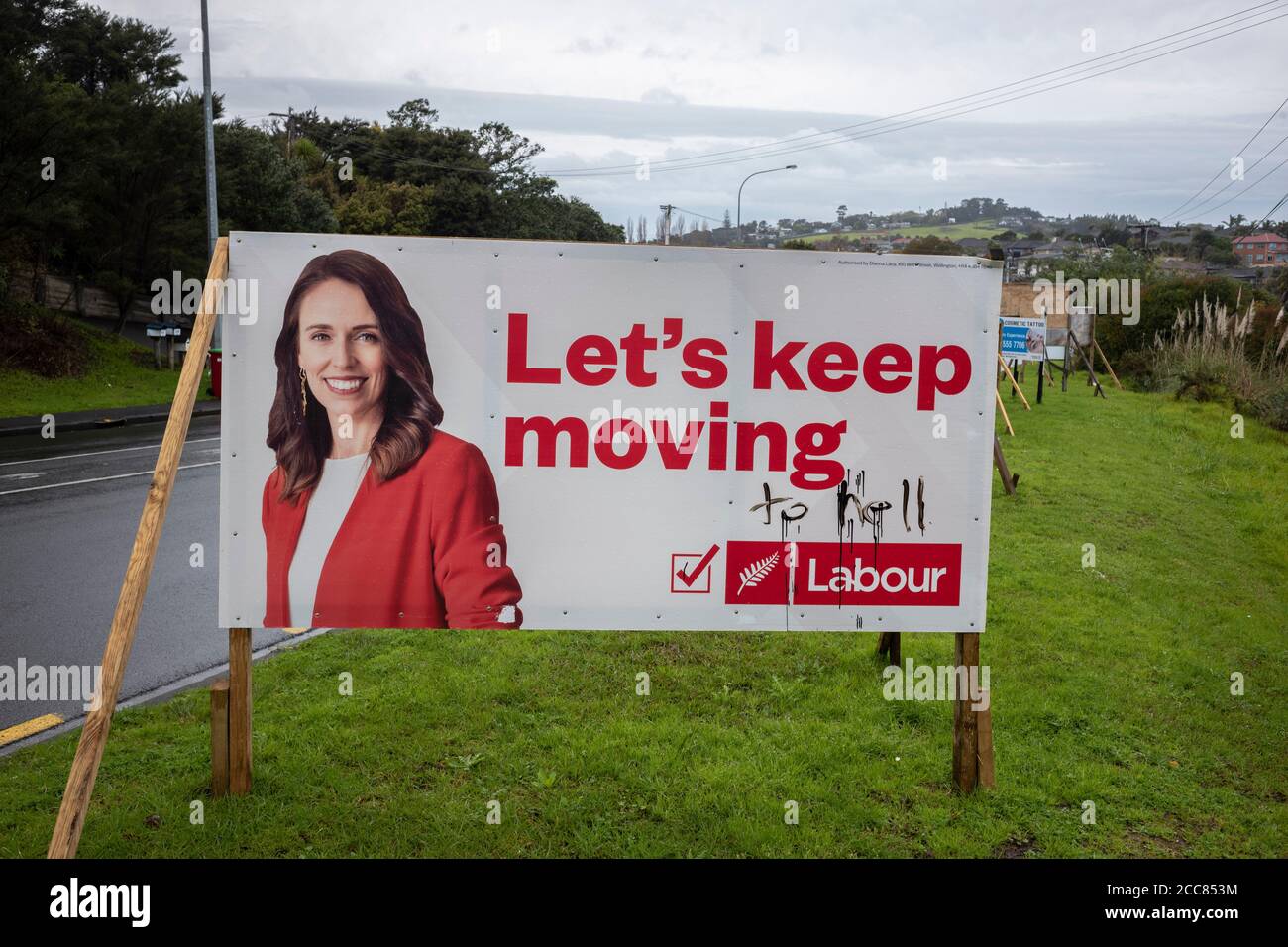 Defaced Labour party Billboard featuring Labour leader and Prime Minister Jacinda Ardern and local candidate Lorayne Ferguson in Whangaparaoa north of Stock Photo