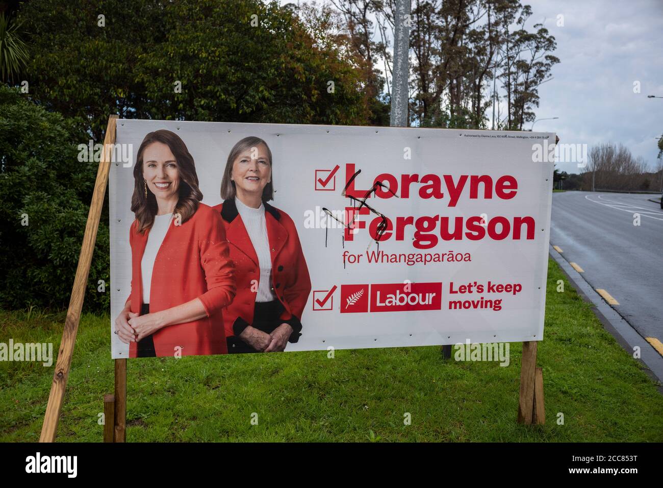 Defaced Labour party Billboard featuring Labour leader and Prime Minister Jacinda Ardern and local candidate Lorayne Ferguson in Whangaparaoa north of Stock Photo