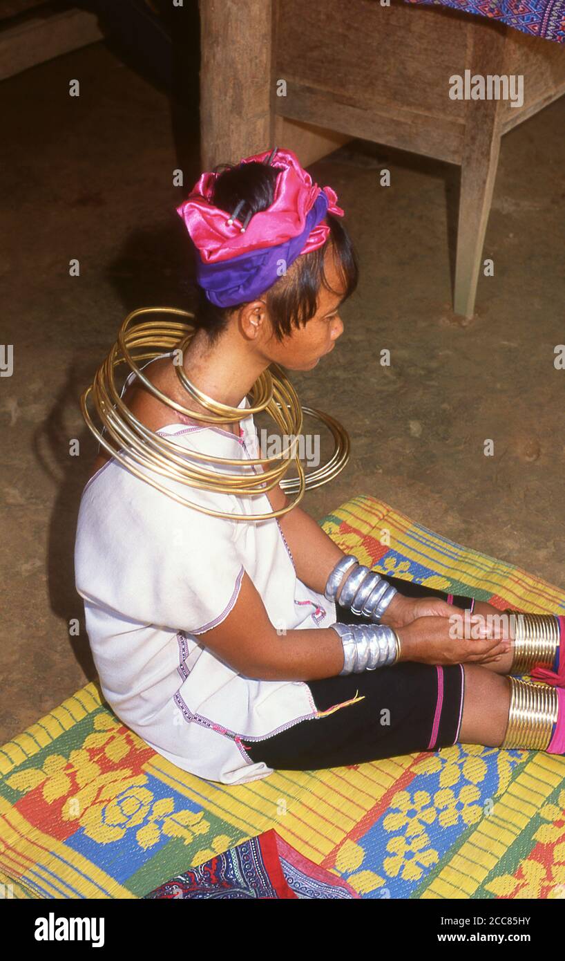 Thailand: A Padaung (Long Neck Karen) woman removing her neck rings for cleaning, village near Mae Hong Son. The Padaung or Kayan Lahwi or Long Necked Karen are a subgroup of the Kayan, a mix of Lawi, Kayan and several other tribes. Kayan are a subgroup of the Red Karen (Karenni) people, a Tibeto-Burman ethnic minority of Burma (Myanmar). Stock Photo