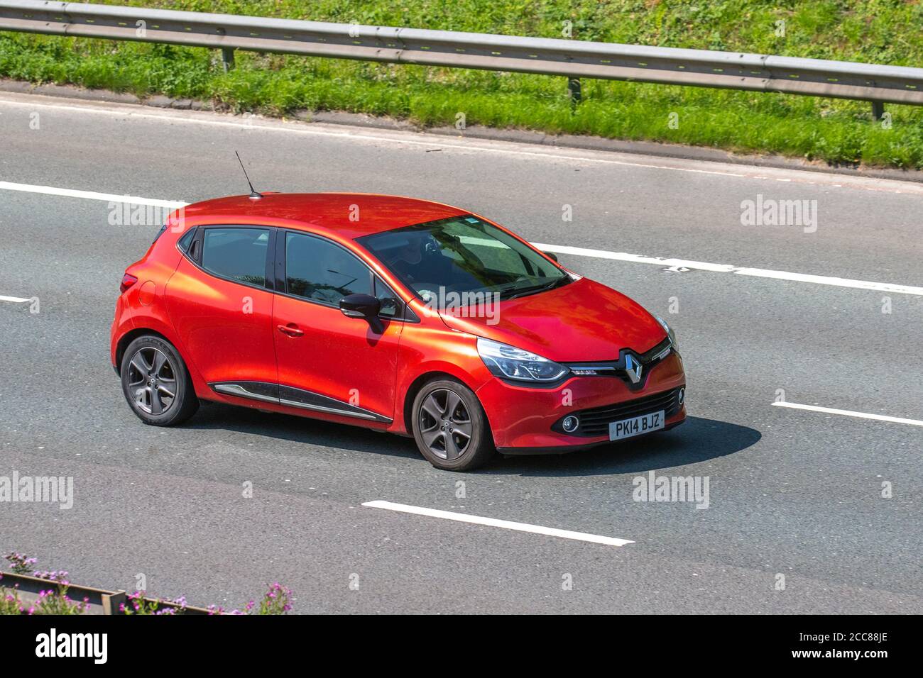 2014 red Renault Clio D-QUE M-Nav Energy D; Vehicular traffic moving vehicles, cars driving vehicle on UK roads, motors, motoring on the M6 motorway highway network. Stock Photo