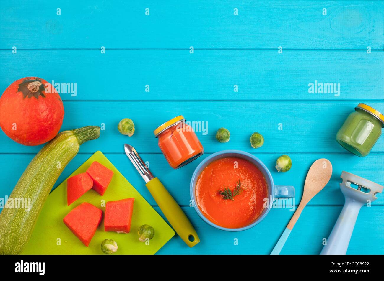 Fresh natural pumpkin puree for baby on blue background Stock Photo